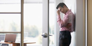 Businessman with Head in Hand